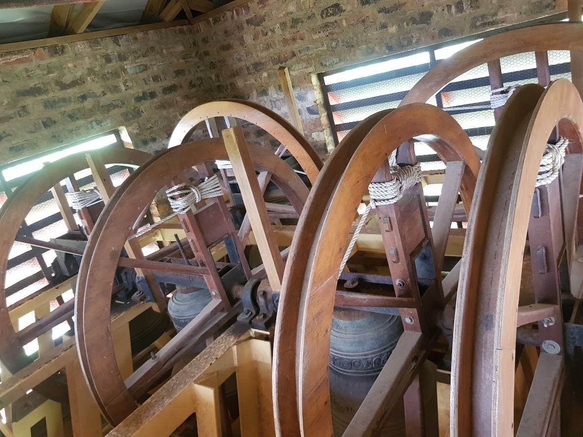 A bell hanging in a restored bell tower at a monastery